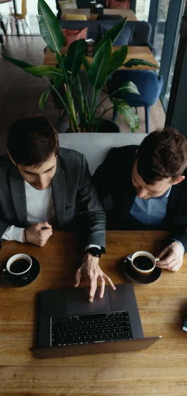 two-young-businessman-having-successful-meeting-restaurant